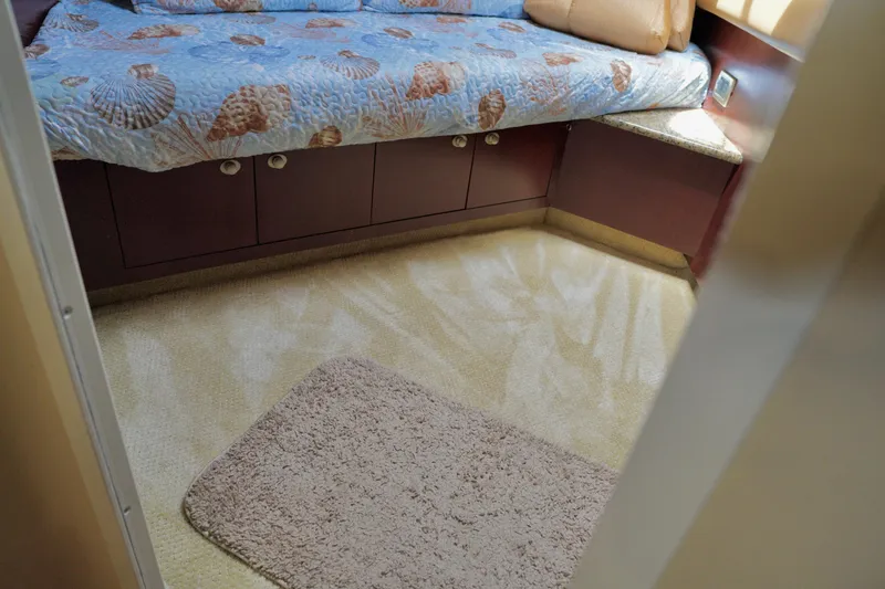 Slide: The Image of Interior cabin of 2006 Sea Ray 40 Motor Yacht with cozy bedding and carpet. - 35