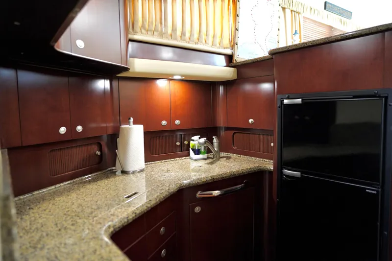 Slide: The Image of Luxurious kitchen interior of 2006 Sea Ray 40 Motor Yacht with wood cabinetry and granite countertops. - 39