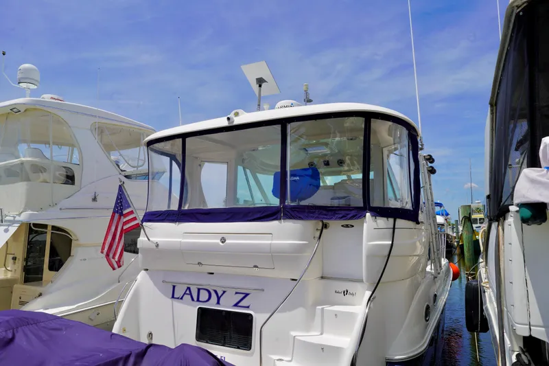 Slide: The Image of 2006 Sea Ray 40 Motor Yacht docked, featuring "Lady Z" name and American flag. - 4