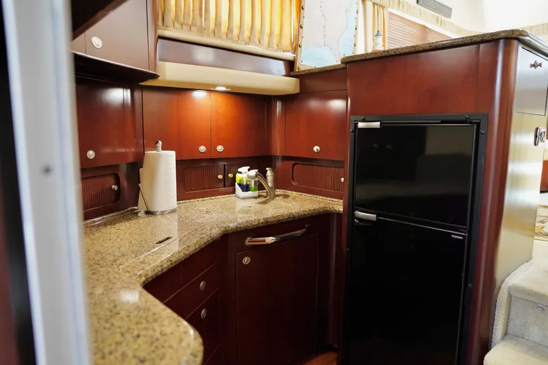 Slide: The Image of Luxurious kitchen interior of 2006 Sea Ray 40 Motor Yacht with granite countertops and wood cabinetry. - 40