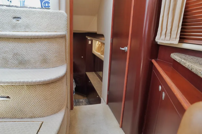 Slide: The Image of Interior view of 2006 Sea Ray 40 Motor Yacht, featuring carpeted stairs and wooden cabinetry. - 50