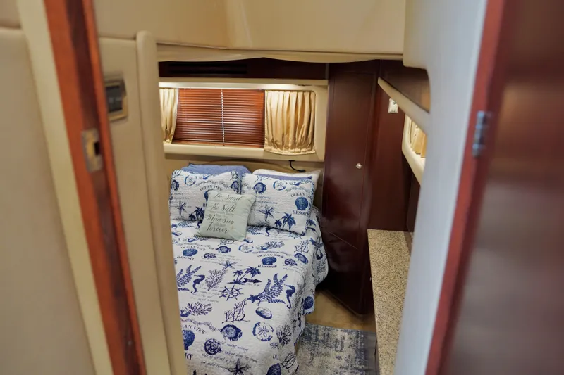 Slide: The Image of Interior cabin of 2006 Sea Ray 40 Motor Yacht with nautical-themed bedding. - 51