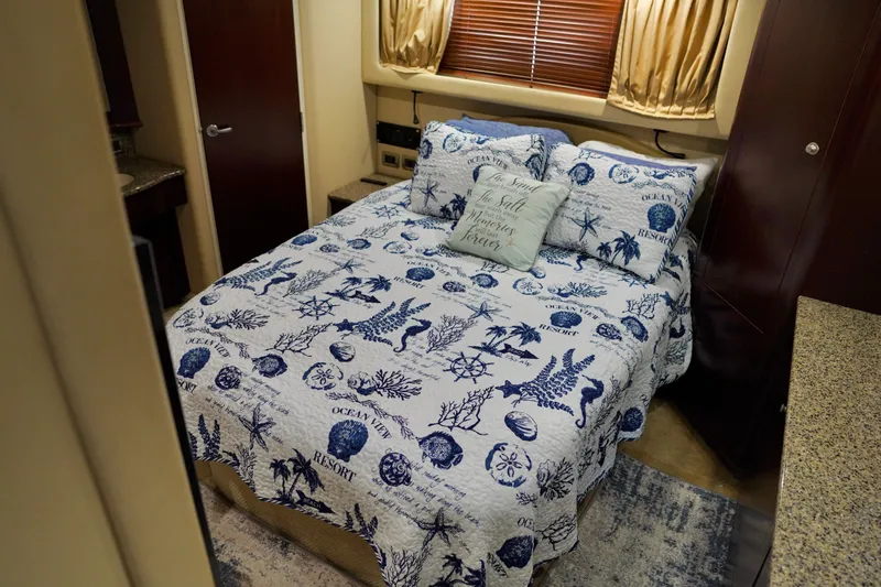 Slide: The Image of Cozy bedroom in 2006 Sea Ray 40 Motor Yacht with nautical-themed bedding. - 53
