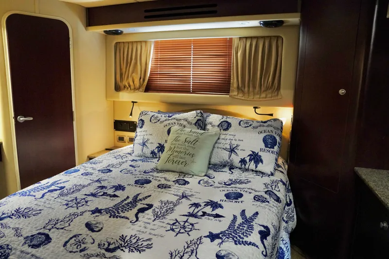 Slide: The Image of Cozy bedroom in 2006 Sea Ray 40 Motor Yacht with nautical-themed bedding. - 54