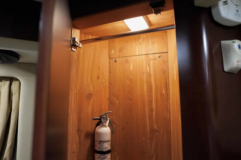 Slide: The Image of Interior of 2006 Sea Ray 40 Motor Yacht with fire extinguisher in wooden cabinet. - 56