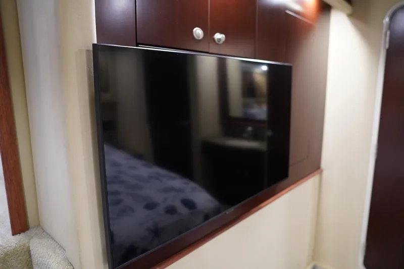 Slide: The Image of Flat-screen TV in 2006 Sea Ray 40 Motor Yacht interior with wooden cabinetry. - 57