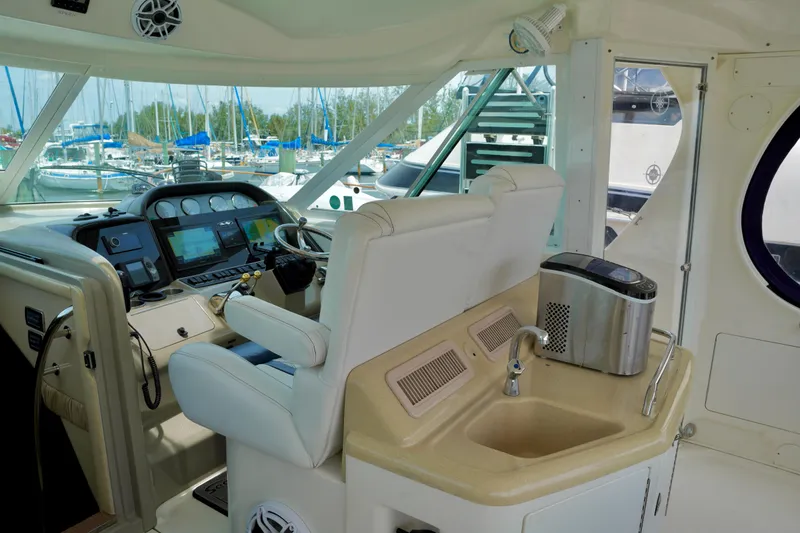 Slide: The Image of 2006 Sea Ray 40 Motor Yacht helm with navigation controls and compact sink area. - 6