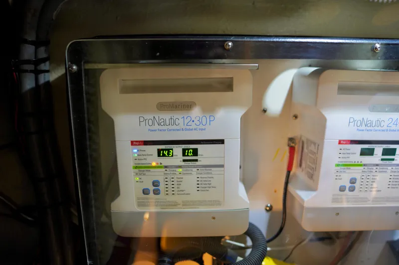 Slide: The Image of ProNautic chargers in 2006 Sea Ray 40 Motor Yacht engine room, displaying voltage and current. - 62