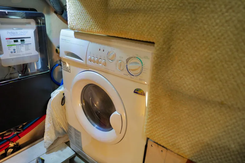 Slide: The Image of Laundry area inside a 2006 Sea Ray 40 Motor Yacht, featuring a washing machine. - 64