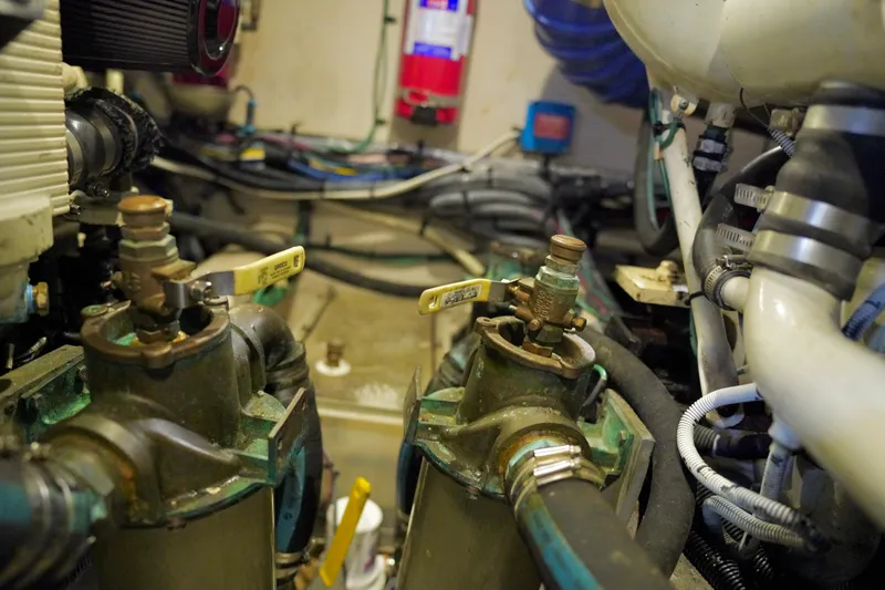Slide: The Image of Engine room of a 2006 Sea Ray 40 Motor Yacht, showcasing mechanical components and valves. - 71