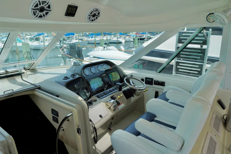 Slide: The Image of 2006 Sea Ray 40 Motor Yacht helm with modern controls and comfortable seating at marina. - 8