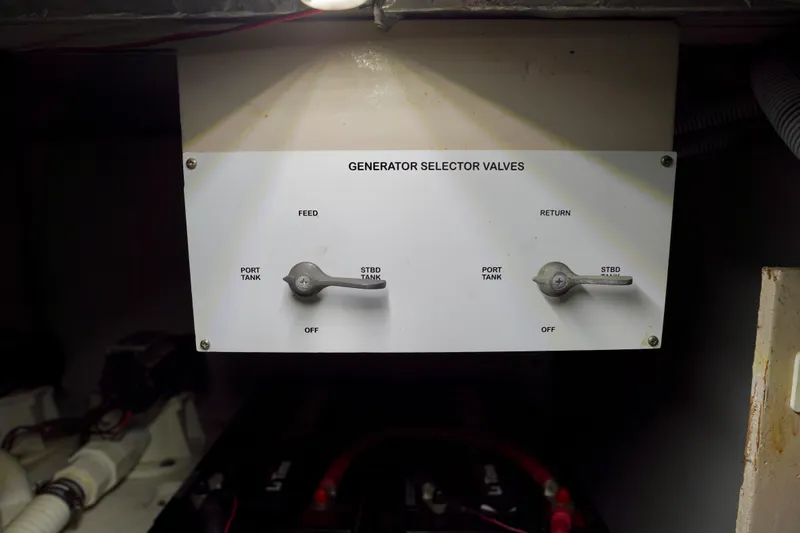 Slide: The Image of Generator selector valves on a 2006 Sea Ray 40 Motor Yacht, showing feed and return controls. - 80
