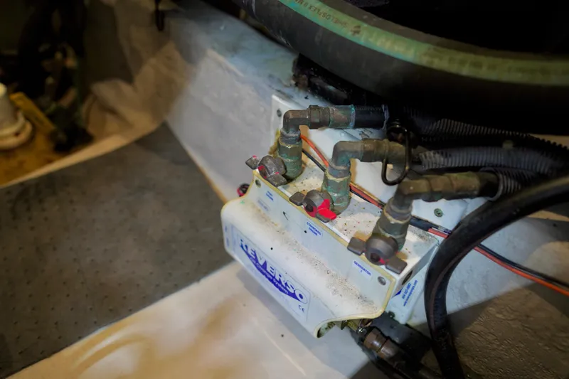 Slide: The Image of Engine room plumbing of a 2006 Sea Ray 40 Motor Yacht, featuring valves and hoses. - 81