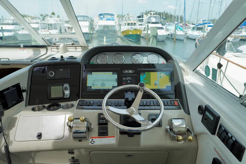 Slide: The Image of Helm of 2006 Sea Ray 40 Motor Yacht with navigation screens and steering wheel. - 9