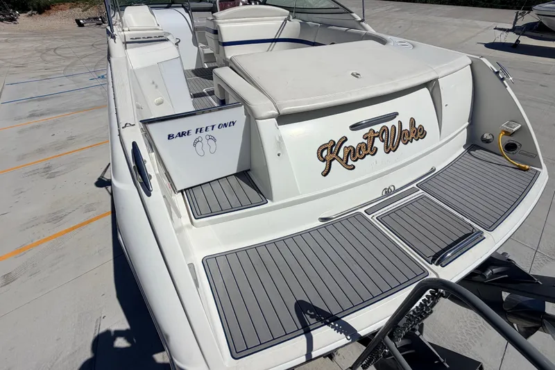 Slide: The Image of 2002 Formula 330 Sun Sport boat with "Knot Woke" name and "Bare Feet Only" sign. - 12