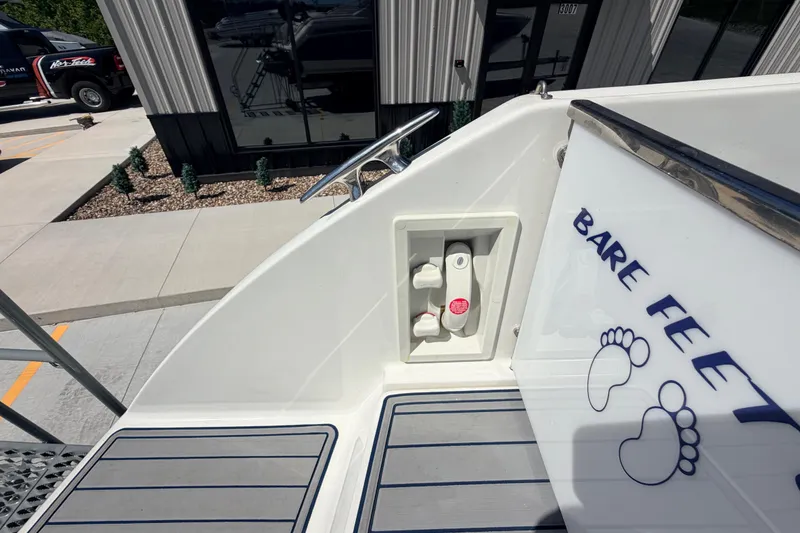Slide: The Image of 2002 Formula 330 Sun Sport boat deck with "Bare Feet" decal and foot graphics. - 13