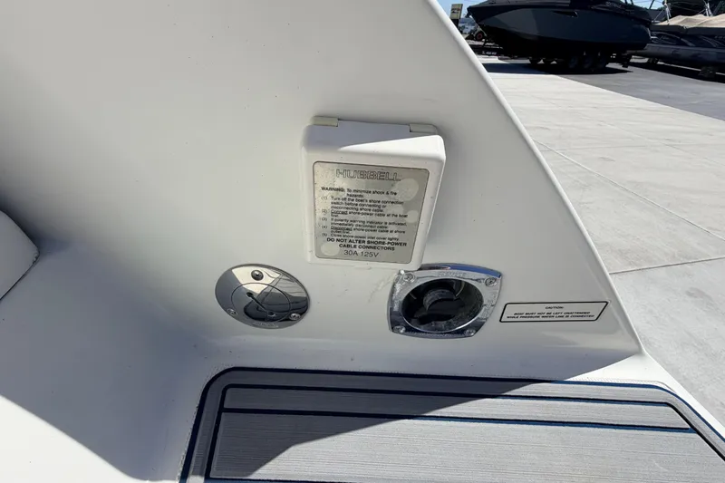 Slide: The Image of 2002 Formula 330 Sun Sport boat power connection and warning label on deck. - 14