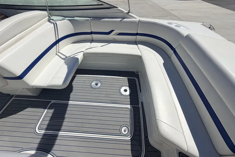 Slide: The Image of 2002 Formula 330 Sun Sport boat interior with white and blue seating, gray deck. - 16