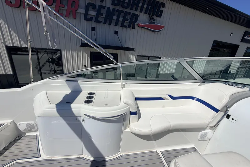 Slide: The Image of 2002 Formula 330 Sun Sport boat interior with white seating and blue accents at a boating center. - 17