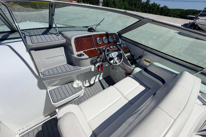 Slide: The Image of 2002 Formula 330 Sun Sport boat cockpit with steering wheel and control panel. - 21