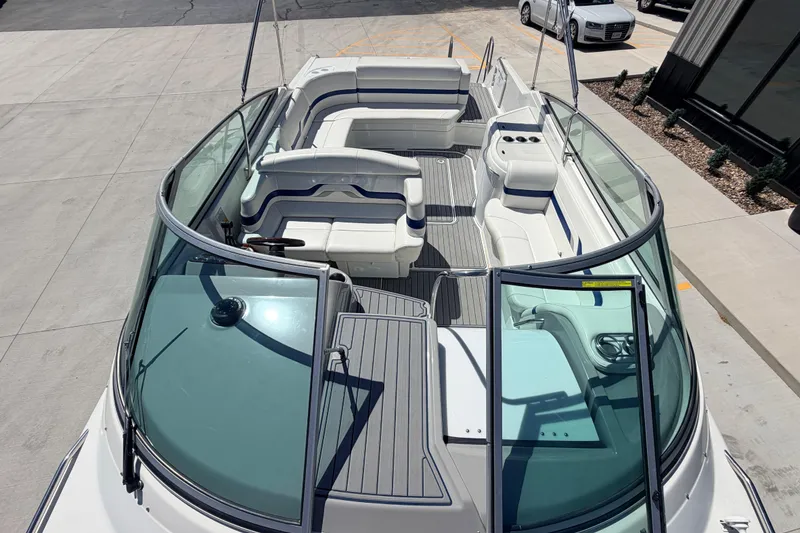 Slide: The Image of 2002 Formula 330 Sun Sport boat with spacious seating and sleek design, docked outdoors. - 23