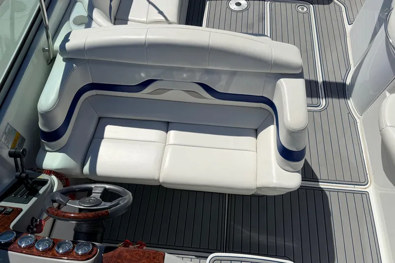 Slide: The Image of 2002 Formula 330 Sun Sport boat interior with white seating and sleek dashboard. - 24