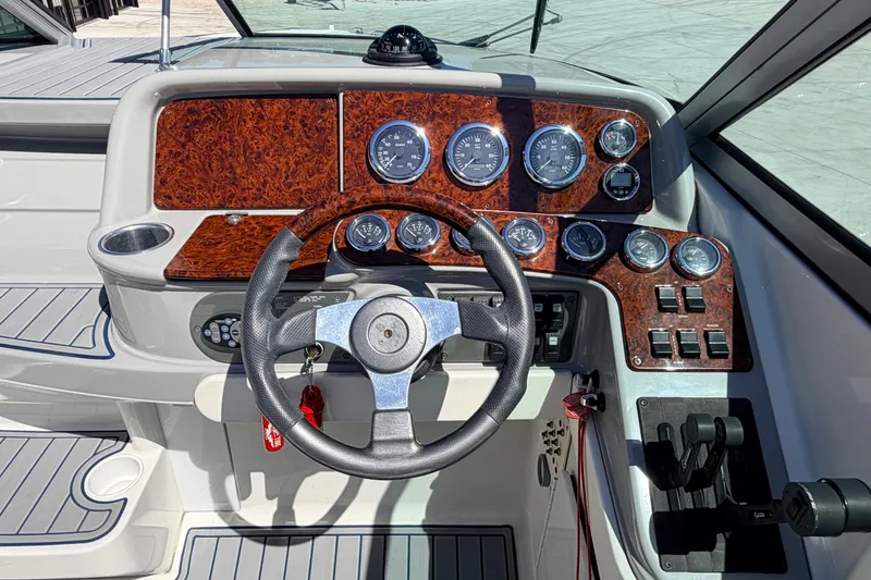 Slide: The Image of Steering console of a 2002 Formula 330 Sun Sport boat with wood paneling and gauges. - 26