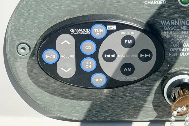Slide: The Image of Kenwood audio control panel on 2002 Formula 330 Sun Sport boat dashboard. - 27