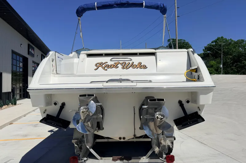 Slide: The Image of 2002 Formula 330 Sun Sport boat, rear view, with dual propellers and "Knot Woke" name. - 3