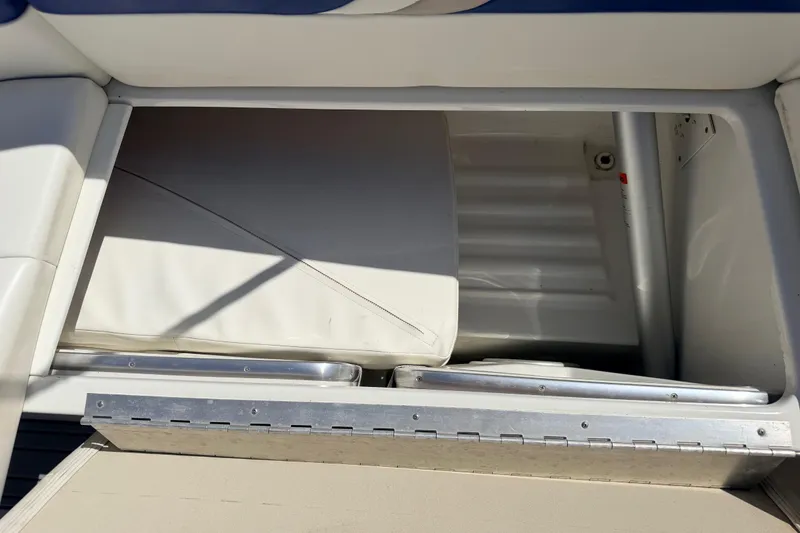Slide: The Image of Storage compartment of a 2002 Formula 330 Sun Sport boat, featuring cushioned seating. - 31