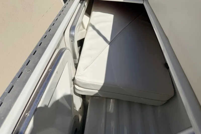 Slide: The Image of Storage compartment in a 2002 Formula 330 Sun Sport boat with white cushions. - 32