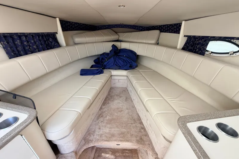 Slide: The Image of Interior of 2002 Formula 330 Sun Sport boat with beige seating and blue curtains. - 34