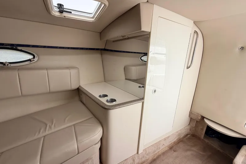 Slide: The Image of Interior of a 2002 Formula 330 Sun Sport boat, featuring beige seating and compact cabinetry. - 37