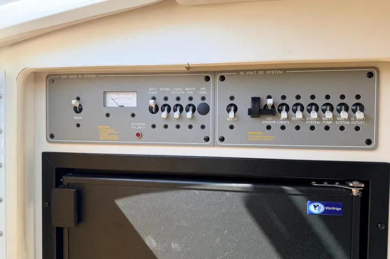 Slide: The Image of Control panel of a 2002 Formula 330 Sun Sport boat, featuring AC and DC systems. - 40