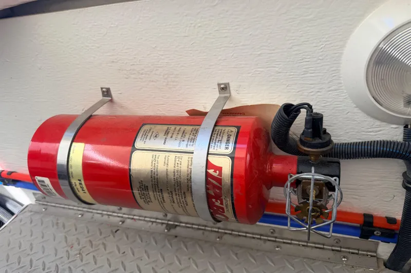 Slide: The Image of Fire extinguisher mounted on a 2002 Formula 330 Sun Sport boat interior. - 46