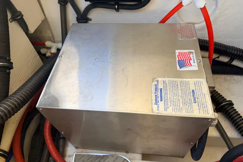 Slide: The Image of Stainless steel box with warning labels in a 2002 Formula 330 Sun Sport boat. - 47