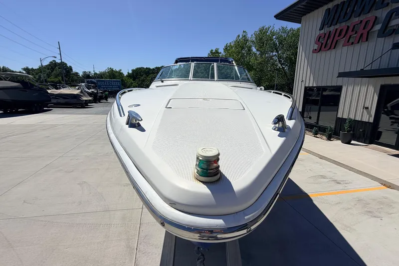 Slide: The Image of 2002 Formula 330 Sun Sport boat displayed outdoors at a dealership. - 7