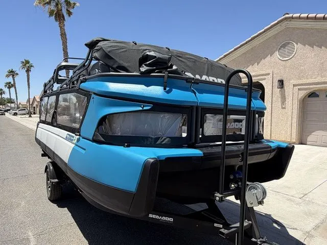 Slide: The Image of 2023 Sea-Doo Switch Cruise 21 on trailer, blue, in sunny residential area. - 6