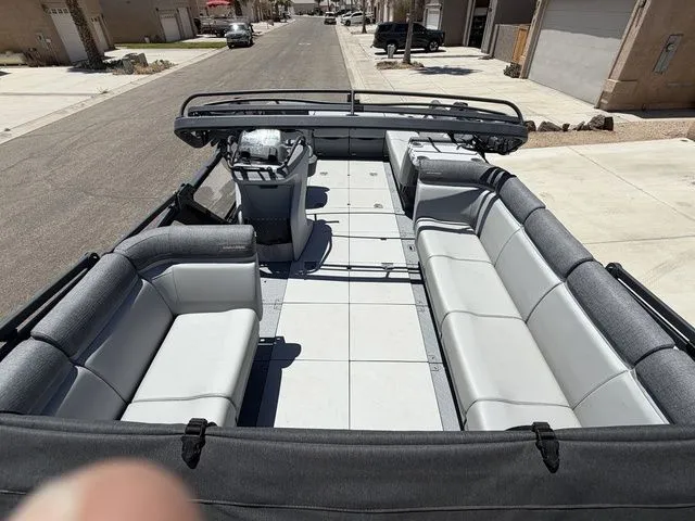 Slide: The Image of 2023 Sea-Doo Switch Cruise 21 pontoon boat parked on a street. - 7