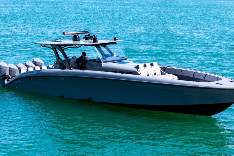 Slide: The Image of 2023 Midnight Express 43 Solstice boat on clear blue water. - 2