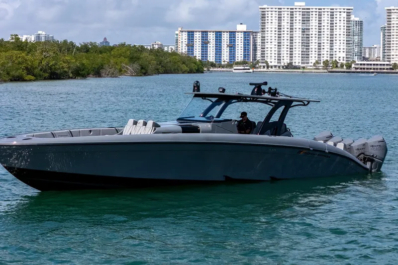 Slide: The Image of 2023 Midnight Express 43 Solstice boat on water with cityscape background. - 7