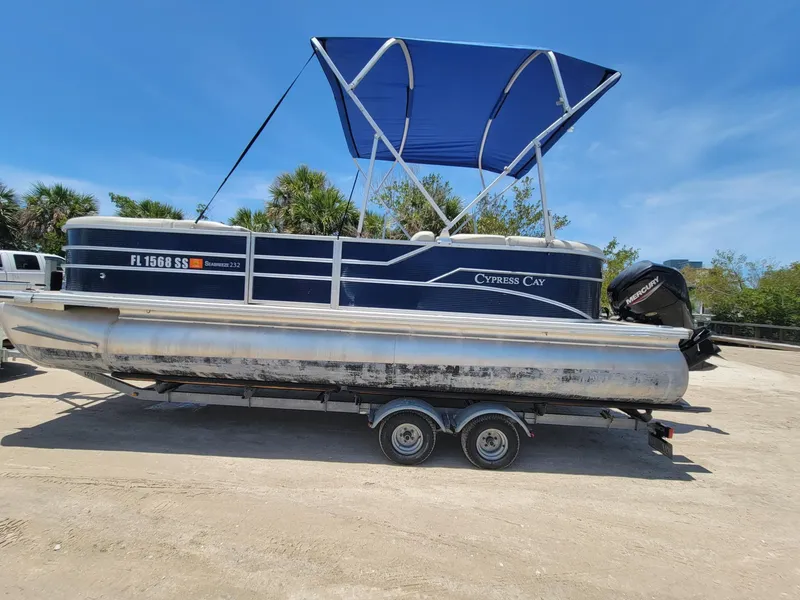 Slide: The Image of 2020 Cypress Cay 232 Seabreeze pontoon boat with blue canopy on trailer. - 3