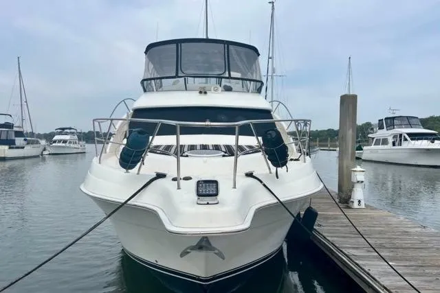 Slide: The Image of 2003 Silverton 43 Motor Yacht docked at a marina, front view. - 1