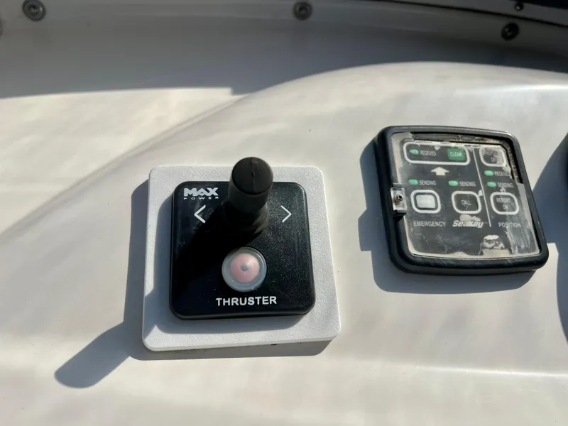 Slide: The Image of Control panel of a 2003 Silverton 43 Motor Yacht, featuring thruster and navigation controls. - 12