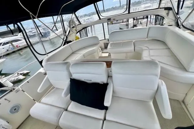Slide: The Image of Luxurious 2003 Silverton 43 Motor Yacht with spacious white seating and marina view. - 18