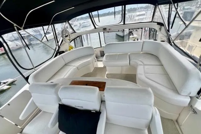 Slide: The Image of 2003 Silverton 43 Motor Yacht interior with spacious white seating and panoramic windows. - 19