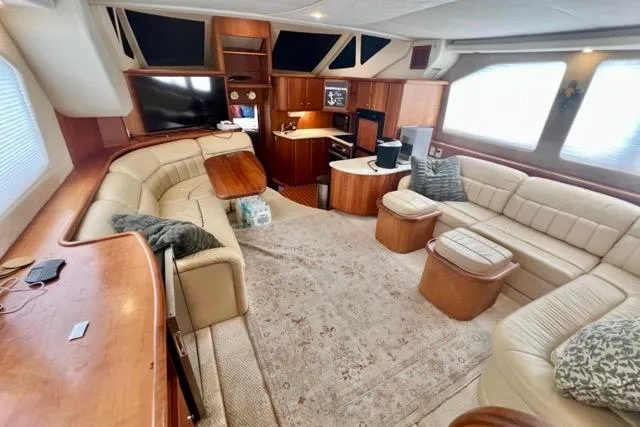 Slide: The Image of Luxurious interior of a 2003 Silverton 43 Motor Yacht with plush seating and elegant wood finishes. - 22