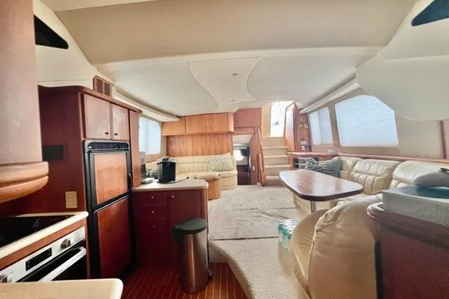 Slide: The Image of Luxurious interior of a 2003 Silverton 43 Motor Yacht with spacious seating and modern amenities. - 23