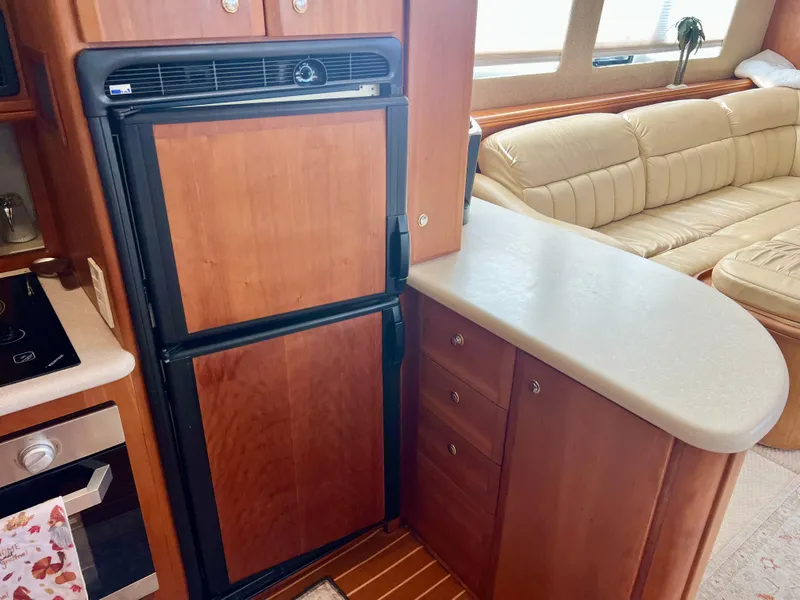 Slide: The Image of 2003 Silverton 43 Motor Yacht interior with kitchen and seating area. - 27