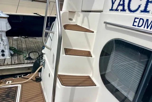 Slide: The Image of Staircase on 2003 Silverton 43 Motor Yacht with wooden steps at dock. - 3